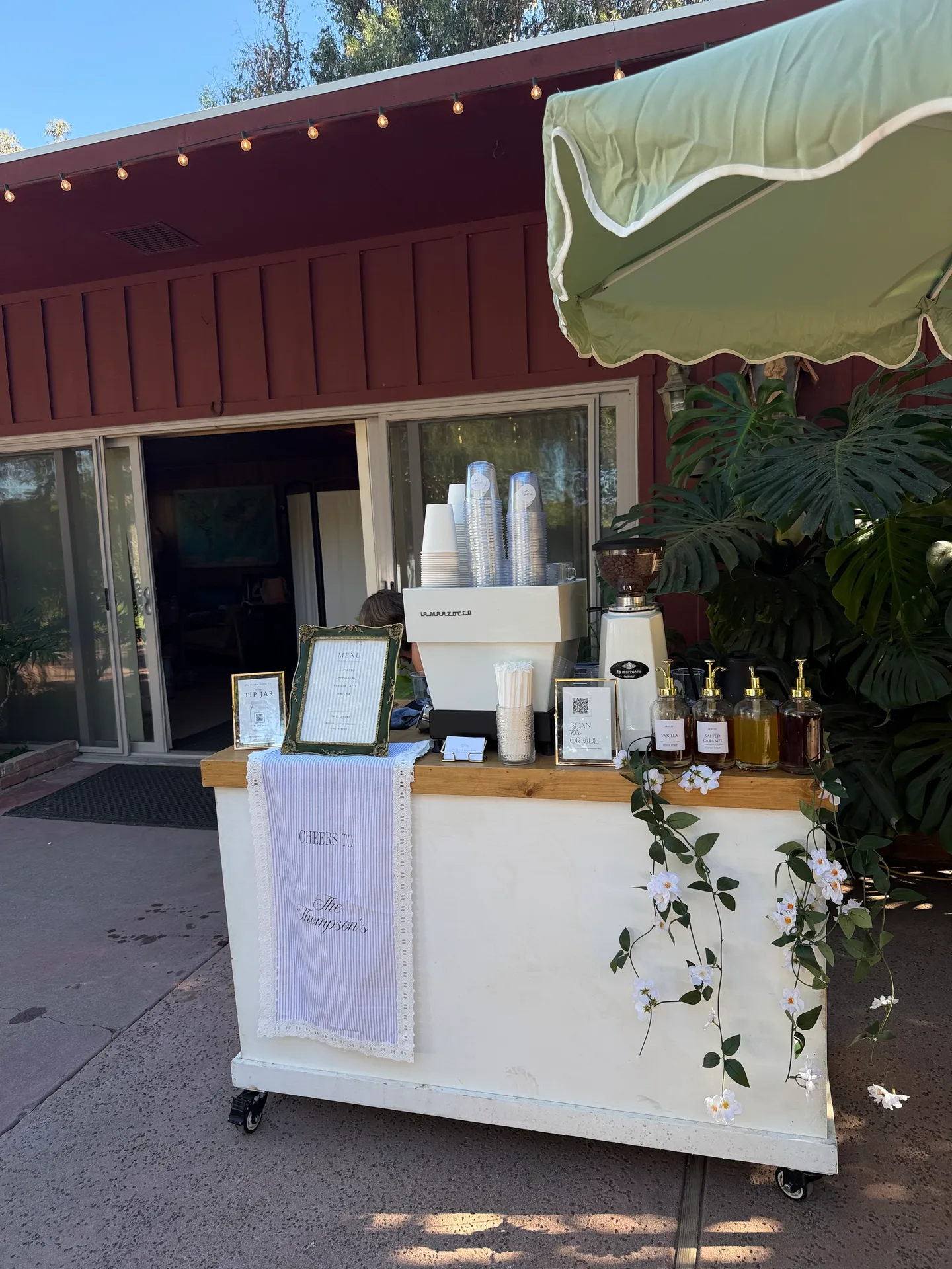 The Garden Coffee Cart Co. espresso cart styled with flowers and a custom wedding menu