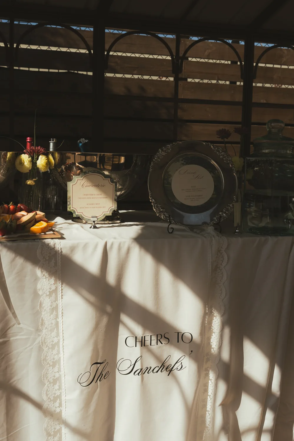 Wedding welcome table with floral arrangement and candlelight