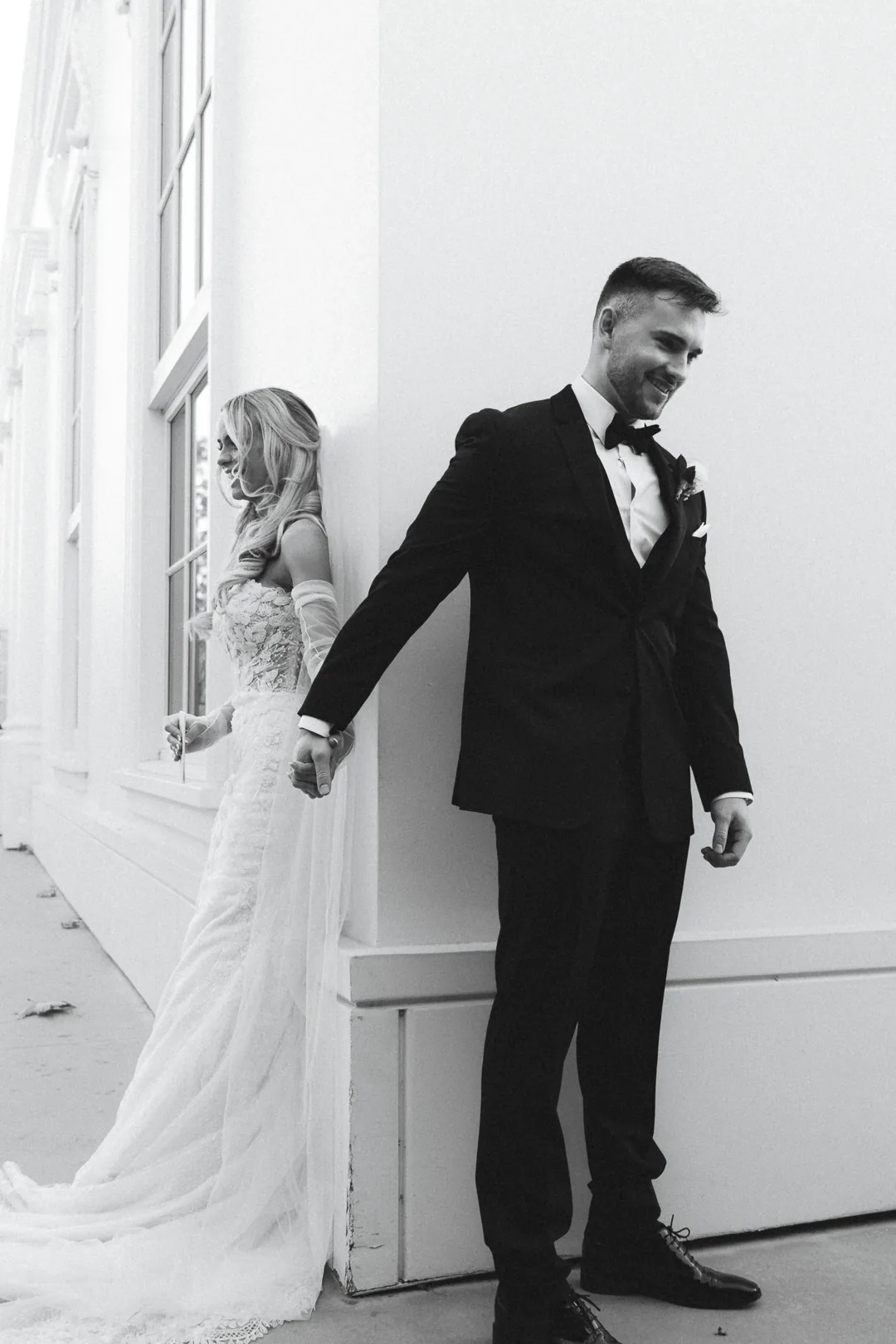 Couple standing apart before their first look