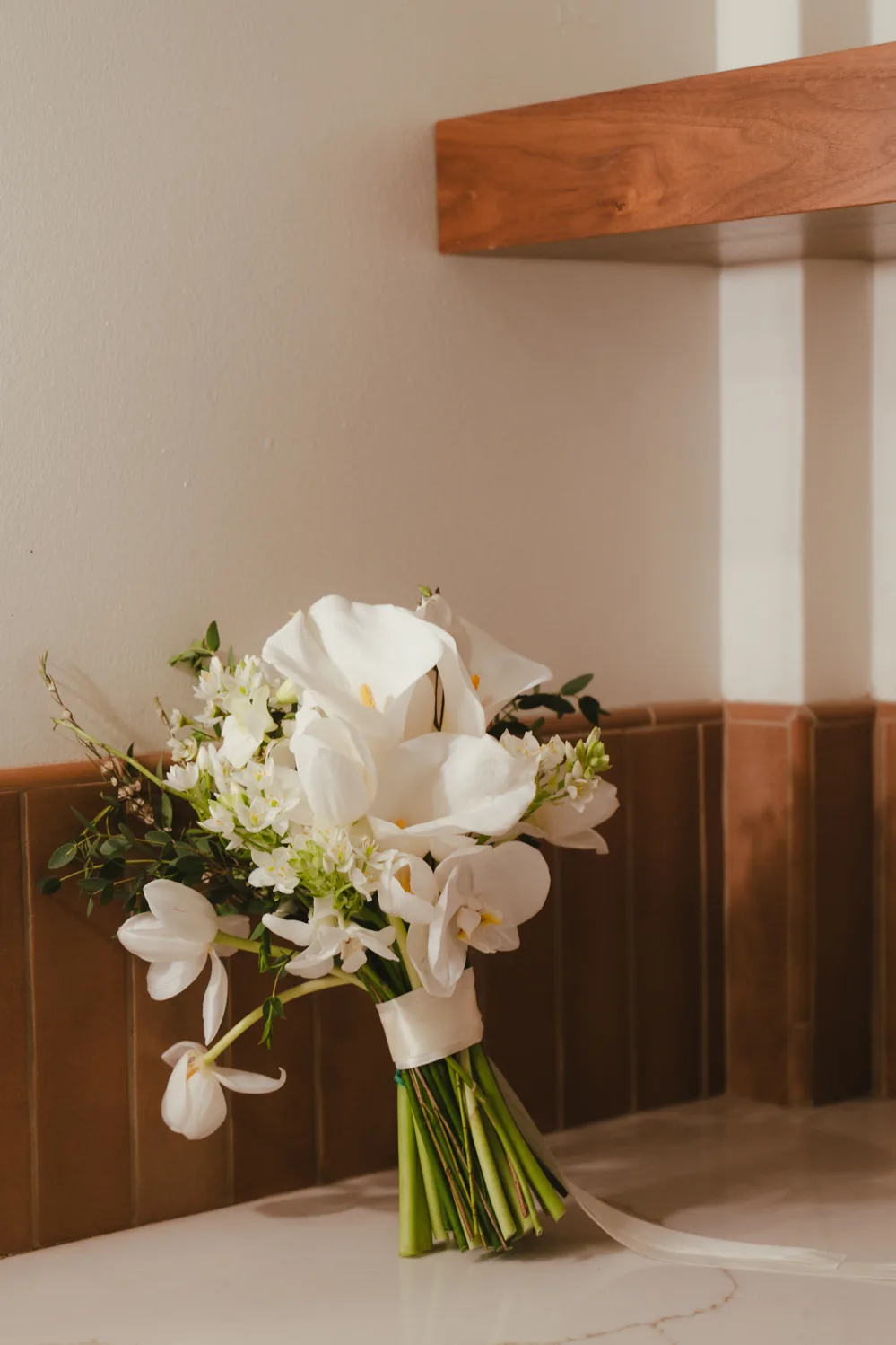 White bridal bouquet displayed in a reception room