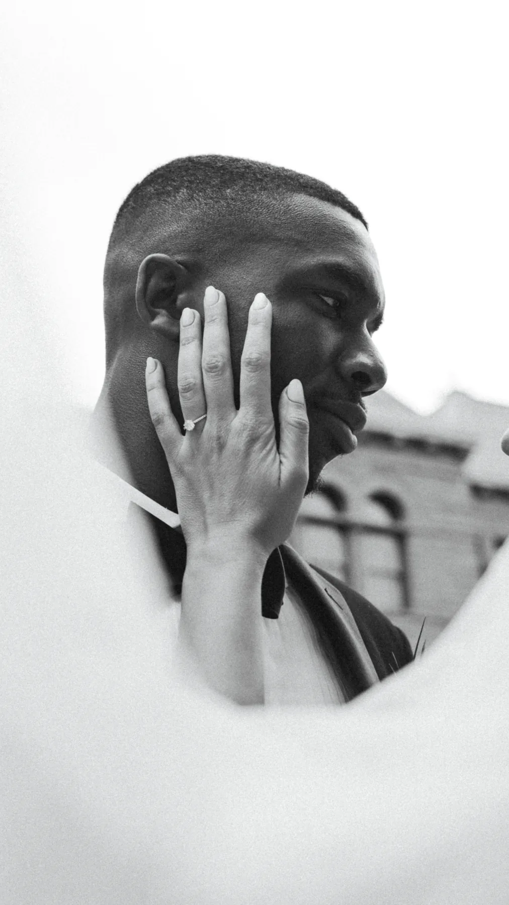 Black and white close portrait of a groom
