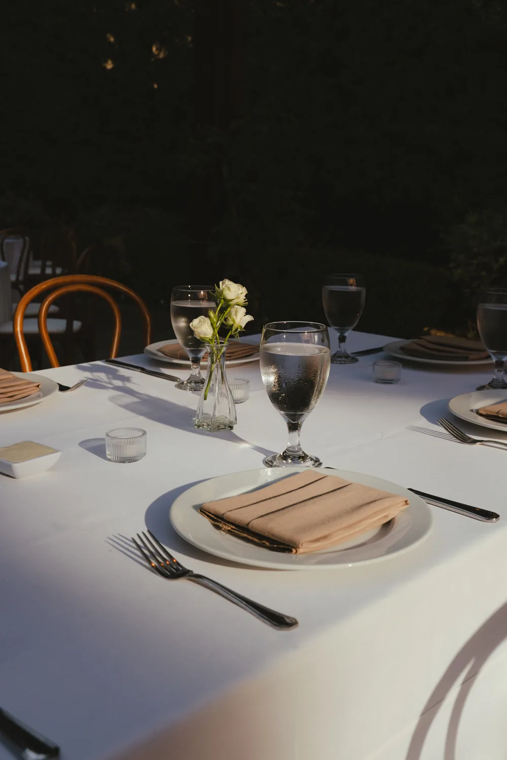 Wedding reception table set for guests at night